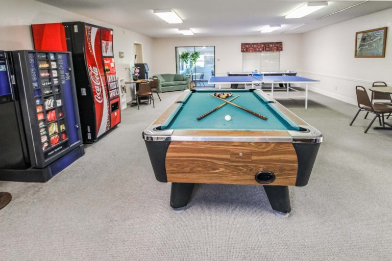 Photo of the Game Room with a Pool Table and vending machines